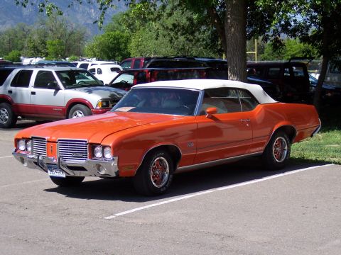 1972 Ford Ranchero - A 1972 Oldsmobile Cutlass Supreme convertible is parked in a lot with other vehicles.