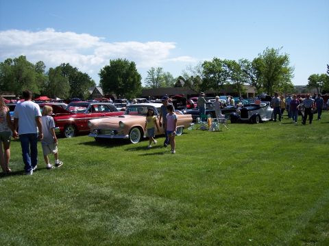 1972 Ford Ranchero - A classic pink Ford Thunderbird is displayed at a car show with other vehicles and attendees.