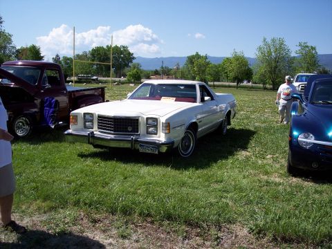1972 Ford Ranchero - A white 1977 Ford Ranchero is parked on a grassy field next to other vehicles.