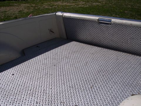 1972 Ford Ranchero - The interior of a truck bed is lined with diamond plate metal for durability.