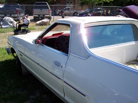 1972 Ford Ranchero - A white 1972 Ford Ranchero is parked outdoors with other vehicles in the background.