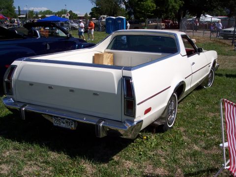 1972 Ford Ranchero - A white 1972 Ford Ranchero is parked on grass at a car show, viewed from the rear.