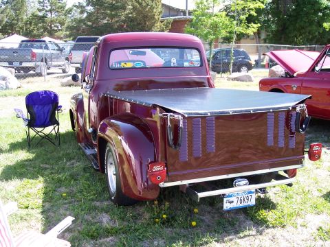 1972 Ford Ranchero - Maroon Ford pickup truck at an outdoor car show, with another vehicle visible to the right.