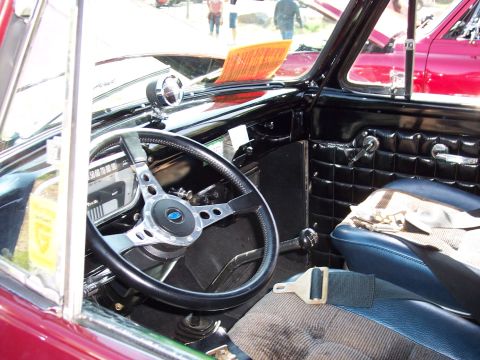 1972 Ford Ranchero - The interior of a 1972 Ford Ranchero features an aftermarket steering wheel, blue seats, and quilted door panels.