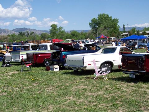 1972 Ford Ranchero - A white 1972 Ford Ranchero is parked at an outdoor car show alongside other vehicles.