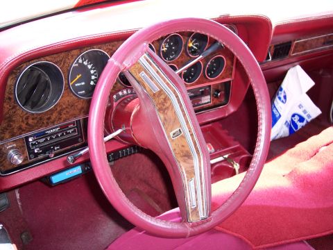 1972 Ford Ranchero - Interior view of a 1977 Ford Thunderbird, woodgrain trim on the dashboard and steering wheel.