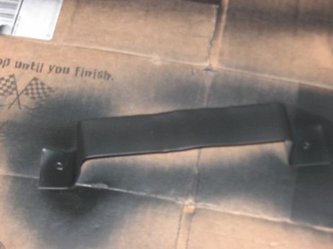 1991 Ford Bronco - A black handle is shown against a cardboard background with spray paint and checkered flag graphics.