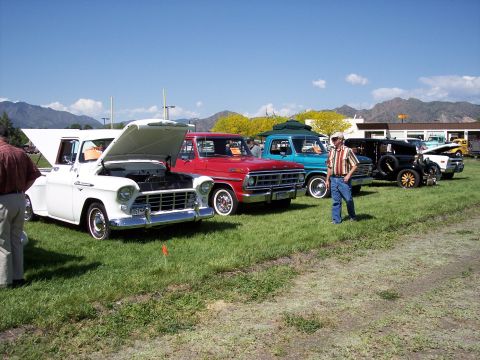 1972 Ford Ranchero - Several vintage vehicles are displayed outdoors on a sunny day with mountains in the background.