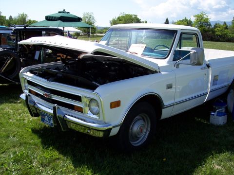 1972 Ford Ranchero - A white 1971 Chevrolet pickup truck is displayed with its hood open at an outdoor car show.