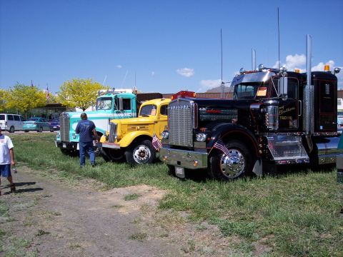 1972 Ford Ranchero - Several classic semi-trucks are displayed outdoors under a clear blue sky.