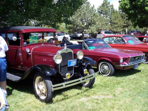 1972 Ford Ranchero - Two classic Ford vehicles are displayed on a grassy field under trees, with other cars in the background.