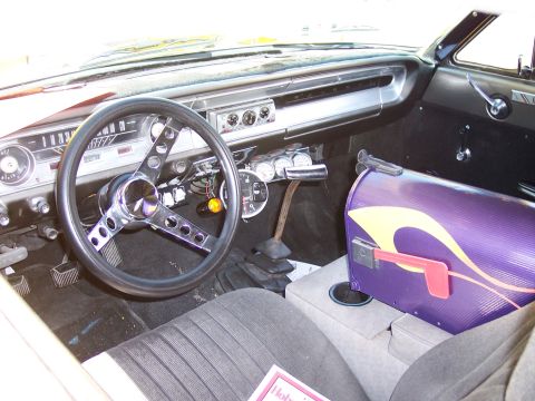 1972 Ford Ranchero - The interior of a classic car features a custom purple mailbox console and an aftermarket steering wheel.