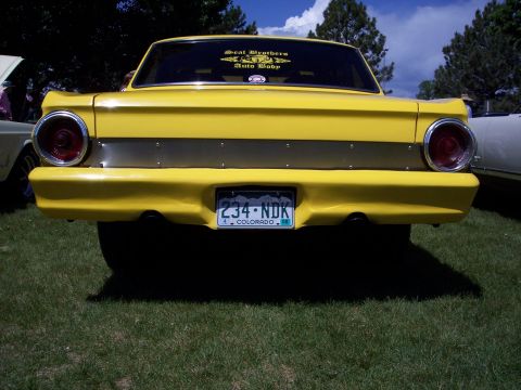1972 Ford Ranchero - A yellow 1972 Ford Ranchero is seen from the rear at a car show, with a Colorado license plate and a sticker on the back window.