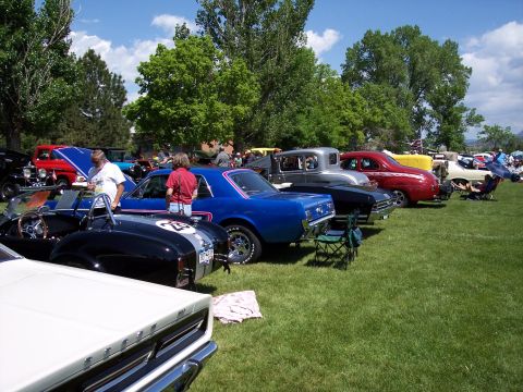 1972 Ford Ranchero - Several classic cars are displayed on a grassy field under a partly cloudy sky.