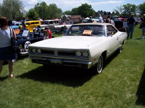 1972 Ford Ranchero - A white 1969 Dodge Coronet coupe is displayed at an outdoor car show.