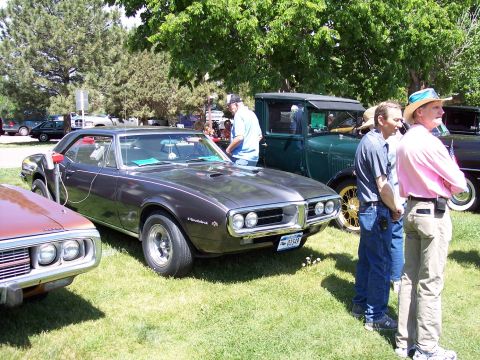 1972 Ford Ranchero - A 1967 Pontiac Firebird is displayed at a car show with other vehicles present.