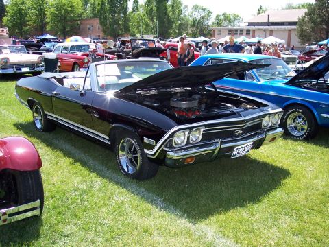1972 Ford Ranchero - Black SS convertible at a car show, hood open, with other vehicles in the background.