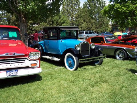 1972 Ford Ranchero - A blue vintage coupe is displayed at an outdoor car show with other vehicles.