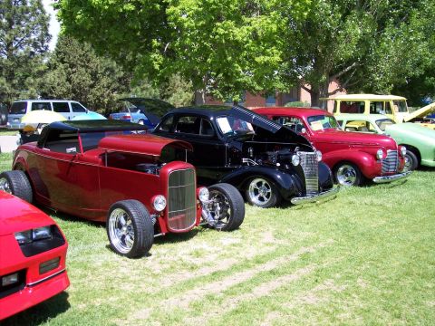 1972 Ford Ranchero - A collection of vintage automobiles are displayed outdoors on a sunny day at a car show.