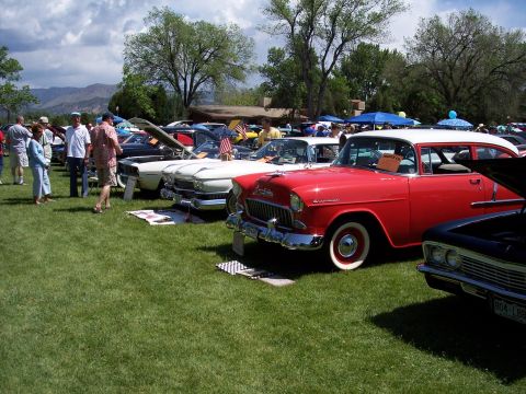 1972 Ford Ranchero - A red and white 1955 Chevrolet Bel Air is displayed at a car show with other vintage vehicles.