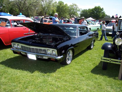 1972 Ford Ranchero - A black 1965 Chevrolet coupe is displayed with its hood open at an outdoor car show.