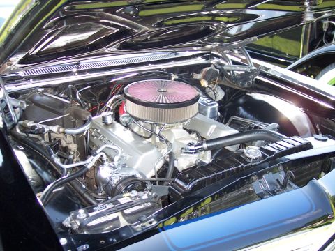 1972 Ford Ranchero - The engine bay of a car is shown with a prominent V8 engine and chrome air cleaner.