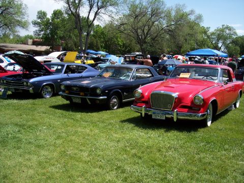 1972 Ford Ranchero - A red coupe with a distinctive grille is displayed at an outdoor car show.