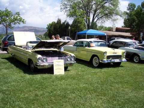 1972 Ford Ranchero - Two classic cars, including a 1955 Chevrolet, are displayed at an outdoor car show.