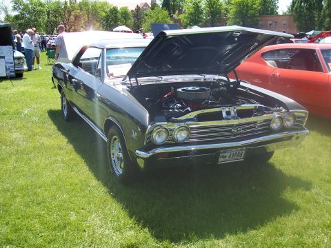 1972 Ford Ranchero - A dark gray coupe, identified by its SS badging and grille, is displayed with its hood open at a car show.