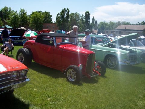 1972 Ford Ranchero - Several vehicles are on display at an outdoor car show on a sunny day.