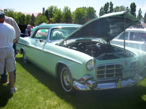 1972 Ford Ranchero - A light green 1955 Chrysler New Yorker is displayed with its hood open at an outdoor car show.