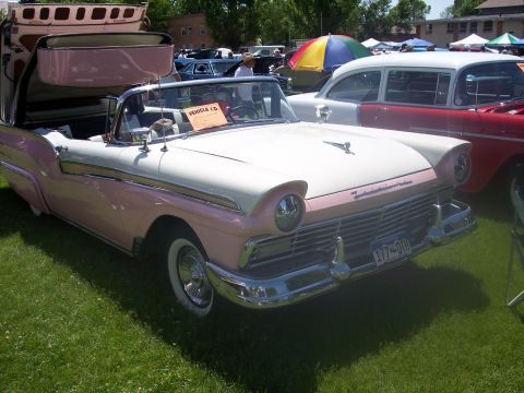1972 Ford Ranchero - A two-tone pink and white 1957 Ford Fairlane 500 Skyliner is displayed at an outdoor car show.