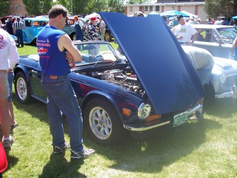 1972 Ford Ranchero - A blue convertible is displayed with its hood open at an outdoor car show.