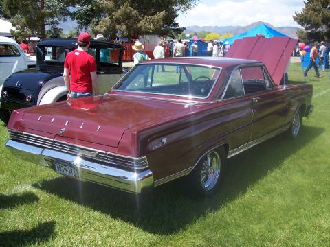 1972 Ford Ranchero - A maroon coupe with its hood open sits on display at an outdoor car show.