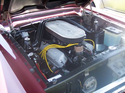 1972 Ford Ranchero - The engine bay of a classic car is shown with its hood open, revealing the motor and associated components.