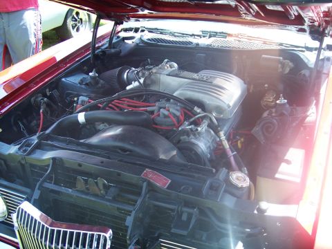 1972 Ford Ranchero - The engine bay of a 1972 Ford Ranchero is displayed, revealing its V8 engine and associated components.