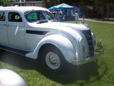 1972 Ford Ranchero - A white sedan with a distinctive grille and fender vents is displayed outdoors.