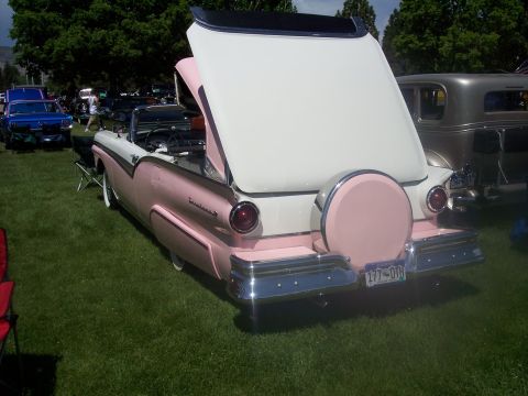 1972 Ford Ranchero - A two-tone pink and white convertible is displayed with its trunk open, revealing a spare tire cover.