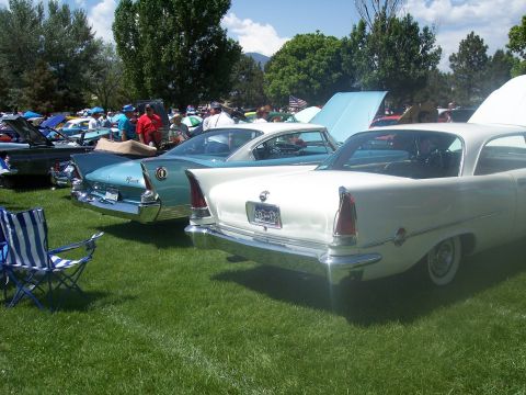 1972 Ford Ranchero - A white 1957 Chrysler 300 is displayed at a car show, distinctive tail fins and a prominent chrome bumper.