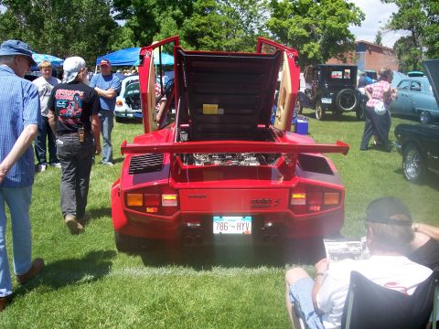 1972 Ford Ranchero - Rear view of a red Lamborghini Countach at a car show, with engine and doors open.