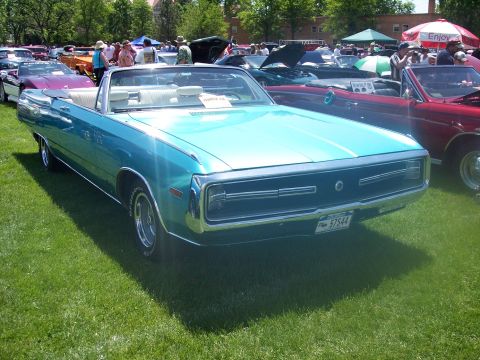 1972 Ford Ranchero - A blue convertible with a white interior is displayed at an outdoor car show.