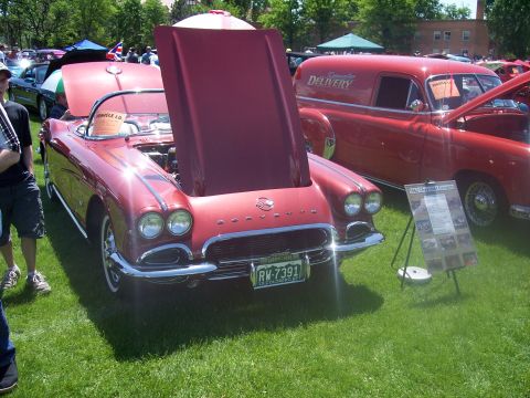 1972 Ford Ranchero - A red 1959 Chevrolet Corvette convertible is displayed with its hood open at a car show.