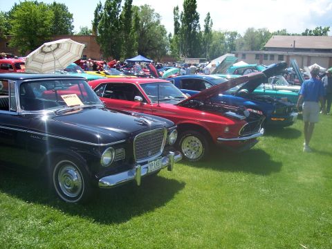 1972 Ford Ranchero - A black 1962 Studebaker Lark is parked at a car show with other vehicles.