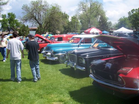1972 Ford Ranchero - A variety of vintage vehicles are displayed on a grassy field at an outdoor car show.