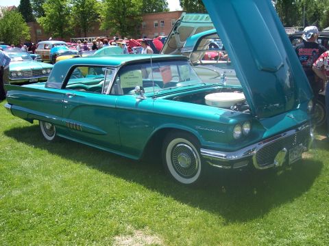 1972 Ford Ranchero - A teal 1959 Ford Thunderbird convertible is displayed with its hood open at a car show, surrounded by other vehicles and attendees.