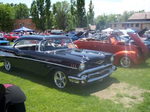1972 Ford Ranchero - A classic black Chevrolet Bel Air is displayed at an outdoor car show, with other vehicles visible in the background.