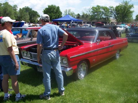 1972 Ford Ranchero - A red convertible with its hood open is displayed at an outdoor car show.