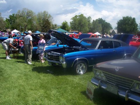 1972 Ford Ranchero - A blue 1972 Chevrolet Chevelle SS coupe is displayed with its hood open at a car show, alongside other vehicles and attendees.