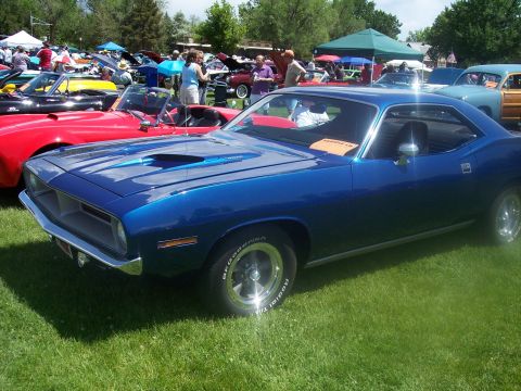 1972 Ford Ranchero - Blue 1970 Plymouth Barracuda at a car show with multiple vehicles present.