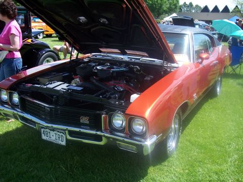 1972 Ford Ranchero - This orange muscle car, identified by its GS badging, is displayed with its hood open at a car show.